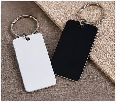 White and black blank aluminum keychains showing printable surfaces